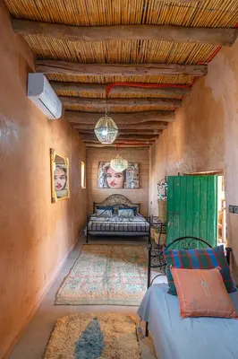 a bedroom with a bed and a couch in a room at Riad Azelia