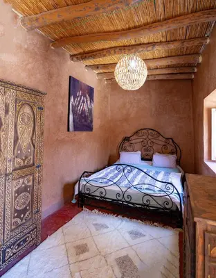 a bedroom with a bed and a chandelier at Riad Azelia