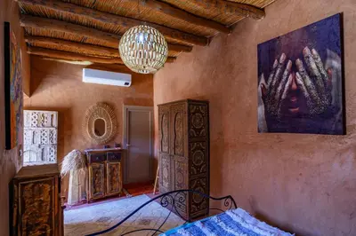 a room with a bed and a painting on the wall at Riad Azelia