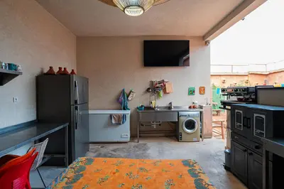 a kitchen with a refrigerator and a sink and a stove at Riad Azelia