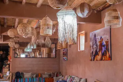 a living room with many chandeliers hanging from the ceiling at Riad Azelia