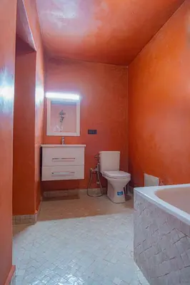 a bathroom with a tub and a toilet and a sink at Riad Azelia