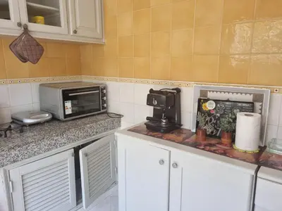 a kitchen with a counter top with a microwave at Villa skhirat swimming pool in Oulad Akkou