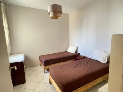 a room with two beds and a lamp at Villa skhirat swimming pool in Oulad Akkou