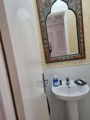 a bathroom with a sink and a mirror at Villa skhirat swimming pool in Oulad Akkou
