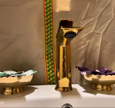 a gold faucet and two bowls on a sink at lion Desert luxury Camp in Merzouga