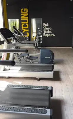 a gym with a treadmill and a keyboard at Appartement in Oulad Akkou