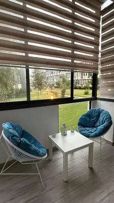a room with two chairs and a table and a window at Appartement in Oulad Akkou