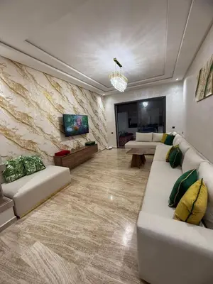 a large living room with couches and a tv at Appartement in Oulad Akkou