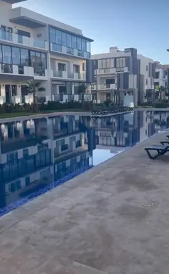 a pool in front of a apartment building at Appartement in Oulad Akkou