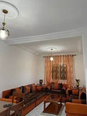 a living room with a couch and a table at Cala iris in Oulad Akkou