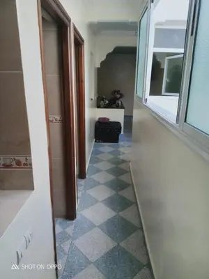 a hallway with a door and a tile floor at Essaouira Mogador in Oulad Akkou