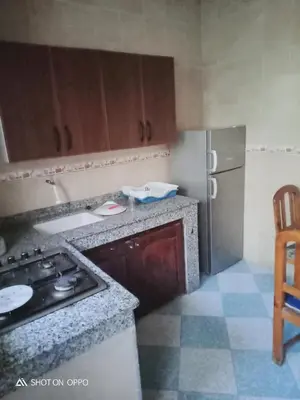 a small kitchen with a stove and a refrigerator at Essaouira Mogador in Oulad Akkou