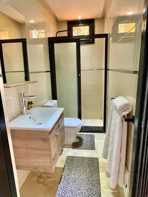 a bathroom with a sink and a toilet at Villa Palmyra, 8 suites et piscine chauffée in Marrakech