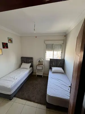a bedroom with two beds and a window at appartement Marrakech in Oulad Akkou