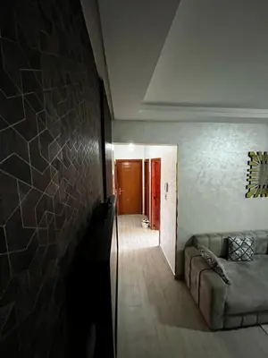 a living room with a couch and a hallway at appartement Marrakech in Oulad Akkou
