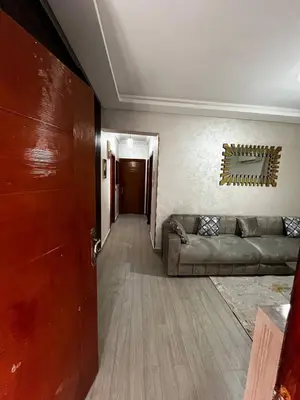 a living room with a couch and a door at appartement Marrakech in Oulad Akkou