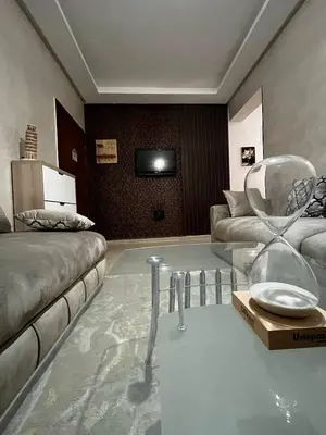 a living room with a couch and a glass table at appartement Marrakech in Oulad Akkou