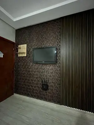 a flat screen tv on a wall in a room at appartement Marrakech in Oulad Akkou