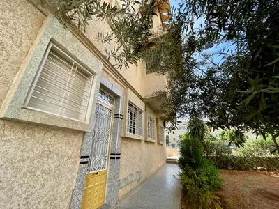 a house with a door and a tree in front of it at Book your stay at Stay Day apartment in Fez in Fès
