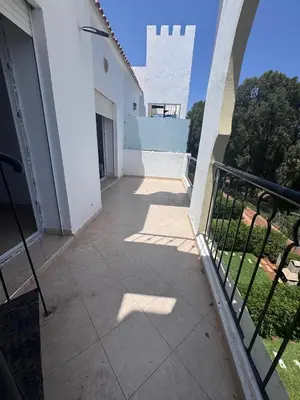 a balcony of a white building with a fence at RESIDENCE SAIDIA AGDAD ap1 in Oulad Akkou