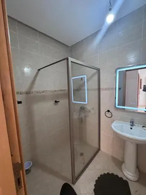 a bathroom with a shower and a sink at RESIDENCE SAIDIA AGDAD ap1 in Oulad Akkou