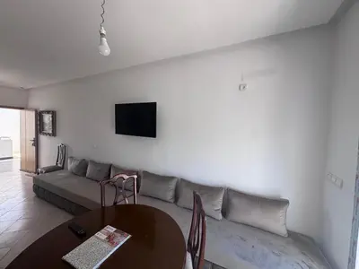 a living room with a couch and a table at RESIDENCE SAIDIA AGDAD ap1 in Oulad Akkou