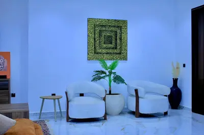 a living room with two chairs and a potted plant at Villa house 24 in Najem