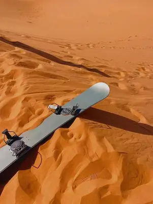 a snowboard in the sand in the desert at moon luxury Dessert camp in Merzouga