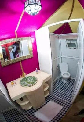 a doll house bathroom with a sink and a toilet at moon luxury Dessert camp in Merzouga