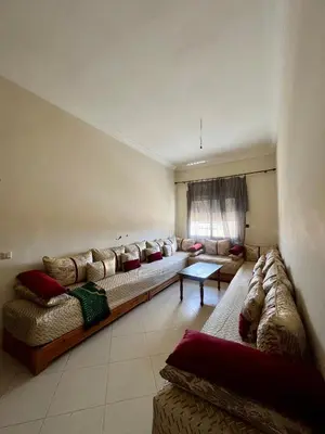 a large living room with couches and a window at Residence Nassim El Bahre in Oulad Akkou