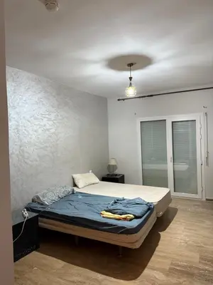 a bedroom with a bed in a room with a ceiling at Le séjour idéal in Oulad Akkou