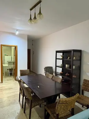 a dining room with a table and chairs at Le séjour idéal in Oulad Akkou