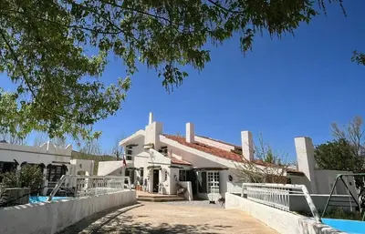 a large white house with a swimming pool at Le Gîte Dayet Aoua