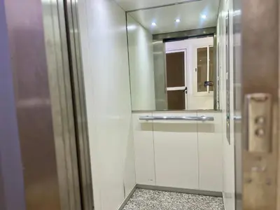 a bathroom with a glass shower with a mirror at Diamond Fes Apartment in Fès