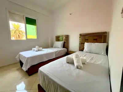 a bedroom with two beds with towels on them at Diamond Fes Apartment in Fès