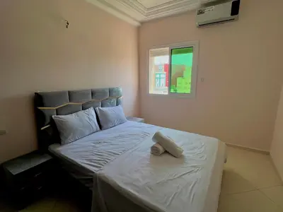 a bedroom with a bed with a towel on it at Diamond Fes Apartment in Fès