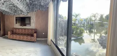 a living room with a couch and a large window at Oasis Serenity in Oulad Akkou