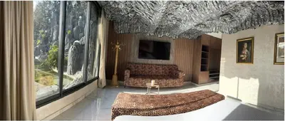 a living room with two couches and a large window at Oasis Serenity in Oulad Akkou