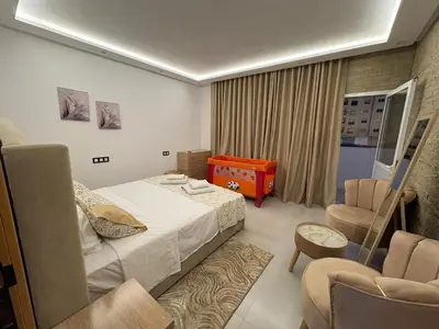 a hotel room with a bed and a chair at New Design in Today's Style in Oulad Akkou