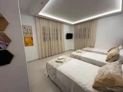 a hotel room with two beds and a mirror at New Design in Today's Style in Oulad Akkou