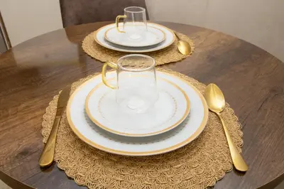 a table with plates and glasses on top of it at Mds1 in Oulad Akkou