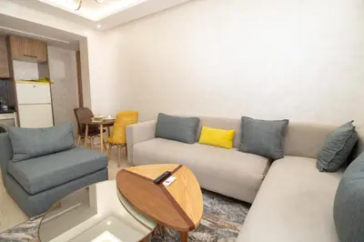 a living room with a couch and chairs and a table at Mds1 in Oulad Akkou