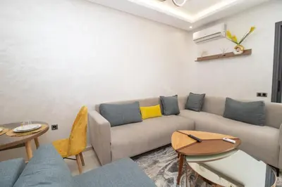 a living room with a couch and tables at Mds1 in Oulad Akkou