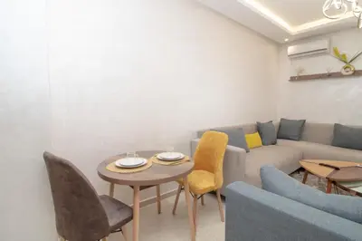 a living room with a couch and a table and chairs at Mds1 in Oulad Akkou