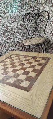 a chess board and a chair on a table at DAIFLAH Guesthouse & Hostel