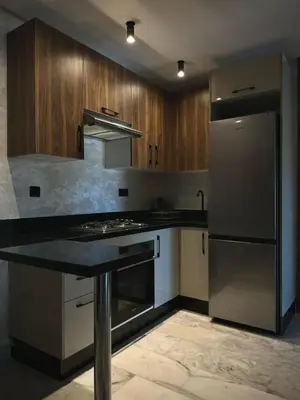 a kitchen with a stove and a refrigerator at Appartement Studio in Oulad Akkou