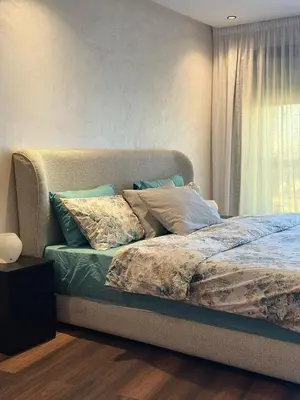 a bedroom with a bed with pillows and a window at Appartement Studio in Oulad Akkou