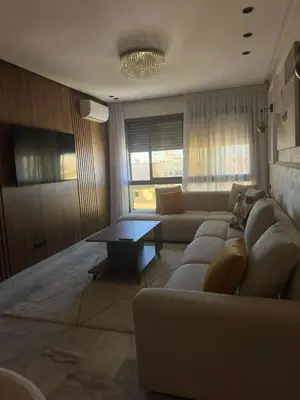 a living room with a couch and a table at Appartement Studio in Oulad Akkou