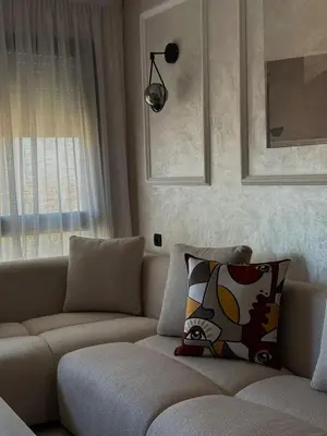 a living room with a couch and a window at Appartement Studio in Oulad Akkou